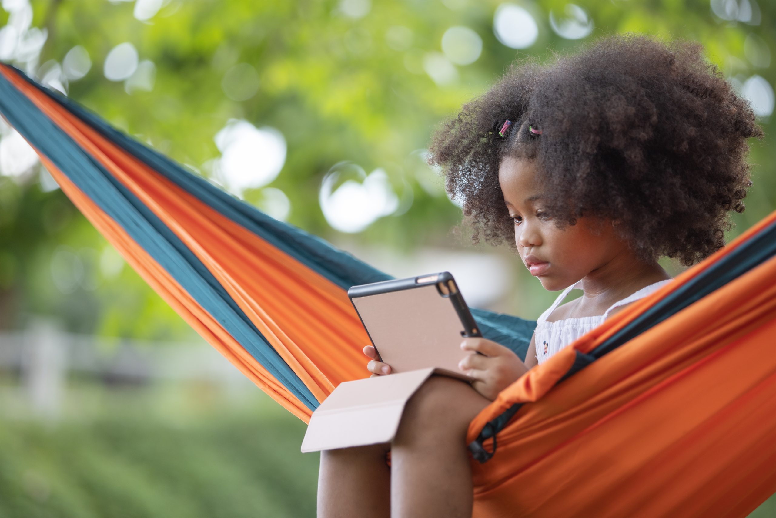 girl-relaxing-in-hammock-with-tablet-outdoors-2026-03-16-01-21-25-utc